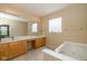 Bright bathroom with double vanity, soaking tub, and tile floors, perfect for relaxation at 14018 Powder Dr, Carmel, IN 46033