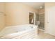 Relaxing bathroom showcasing a luxurious soaking tub and glass-enclosed shower at 14018 Powder Dr, Carmel, IN 46033