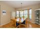 Cozy dining area with bay window, wooden table, and charming chandelier at 14018 Powder Dr, Carmel, IN 46033