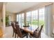 Bright dining room featuring large windows, a glass-top table with seating for six, and neutral decor at 14018 Powder Dr, Carmel, IN 46033