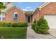 Inviting brick home featuring a covered entryway, manicured bushes, and a well-kept lawn at 14018 Powder Dr, Carmel, IN 46033