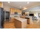Open-concept kitchen with stainless steel appliances, a central island, and hardwood floors at 14018 Powder Dr, Carmel, IN 46033