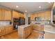 Well-equipped kitchen with stainless steel appliances, a kitchen island, and wood cabinetry at 14018 Powder Dr, Carmel, IN 46033