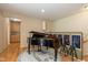 Dedicated piano room featuring hardwood floors, artwork, and seating at 14018 Powder Dr, Carmel, IN 46033