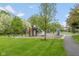 A safe community playground is surrounded by a grassy area, sidewalks, and many trees at 14018 Powder Dr, Carmel, IN 46033