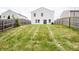 Sloping backyard with lush lawn, privacy fence, and exterior view of the home's back at 1404 Norton Dr, Greenwood, IN 46143