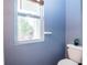Bathroom with a standard toilet and a window bringing in natural light and outdoor view at 1404 Norton Dr, Greenwood, IN 46143