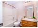 Bright bathroom with a tub, toilet, and vanity with an framed mirror at 1404 Norton Dr, Greenwood, IN 46143
