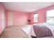 Spacious bedroom with soft carpet and two windows, offering ample natural light with a door at 1404 Norton Dr, Greenwood, IN 46143