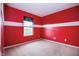 Red bedroom featuring a window and neutral carpet at 1404 Norton Dr, Greenwood, IN 46143