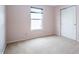 Simple bedroom showcasing a window with blinds and a closet with sliding doors at 1404 Norton Dr, Greenwood, IN 46143