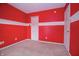 Vibrant bedroom with red walls, carpet, and closet with sliding doors at 1404 Norton Dr, Greenwood, IN 46143
