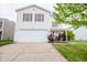 Two-story home features a two-car garage, a front lawn, and landscaping at 1404 Norton Dr, Greenwood, IN 46143