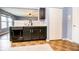 An open kitchen bar with black cabinetry, countertops, and appliances at 1404 Norton Dr, Greenwood, IN 46143