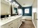 Modern bathroom with double vanity, beautiful mirrors and a tub with blue tiling at 1601 E Edwards Ave, Indianapolis, IN 46227