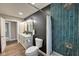 Stylish bathroom with a double vanity and sleek fixtures, complemented by blue tiled shower at 1601 E Edwards Ave, Indianapolis, IN 46227