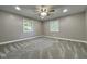 Spacious bedroom featuring carpeted floors, a ceiling fan, and natural light from dual windows at 1601 E Edwards Ave, Indianapolis, IN 46227