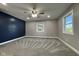 Spacious bedroom featuring carpeted floors, a ceiling fan, and natural light from dual windows at 1601 E Edwards Ave, Indianapolis, IN 46227