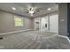 Bedroom featuring carpeted floors, ceiling fan, and access to a walk-in closet and bathroom at 1601 E Edwards Ave, Indianapolis, IN 46227
