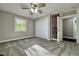 Bedroom with a large window letting in natural light and a ceiling fan at 1601 E Edwards Ave, Indianapolis, IN 46227