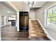 Welcoming entryway featuring wood floors, a built-in mudroom bench, and staircase at 1601 E Edwards Ave, Indianapolis, IN 46227