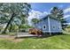 Charming blue home with deck and grassy yard, under a beautiful sunny sky at 1601 E Edwards Ave, Indianapolis, IN 46227