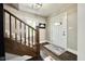 Foyer featuring woodgrain floors, staircase, entry door with glass, and a neutral color palette at 1601 E Edwards Ave, Indianapolis, IN 46227