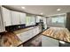 Bright kitchen with white cabinets, butcher block countertops, and stainless steel appliances at 1601 E Edwards Ave, Indianapolis, IN 46227