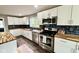 Modern kitchen featuring white cabinets, stainless steel appliances, and stylish backsplash at 1601 E Edwards Ave, Indianapolis, IN 46227