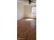 A bright bedroom featuring new, light-colored laminate wood flooring, ceiling fan and a window at 1632 W 8Th W St, Anderson, IN 46016