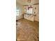A small galley kitchen featuring a stainless steel sink, white cabinets, and a window at 1632 W 8Th W St, Anderson, IN 46016