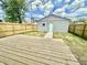 Backyard with wooden deck, fence, and green space, perfect for outdoor gatherings at 1721 Thaddeus St, Indianapolis, IN 46203