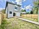 Spacious backyard features a wood deck, fenced yard and green space at 1721 Thaddeus St, Indianapolis, IN 46203