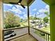 Inviting outdoor deck with a ceiling fan and black metal railings, showcasing a vibrant neighborhood view at 1721 Thaddeus St, Indianapolis, IN 46203