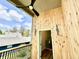 Balcony with natural wood, modern ceiling fan, and exterior view showcases a glimpse inside at 1721 Thaddeus St, Indianapolis, IN 46203
