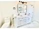 Elegant bathroom with a double vanity, marble floors, and modern fixtures at 1721 Thaddeus St, Indianapolis, IN 46203