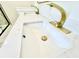 Close up of bathroom sink with quartz counters and golden faucets at 1721 Thaddeus St, Indianapolis, IN 46203