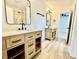 Bathroom featuring dual sinks, modern vanities, updated fixtures, and a shower at 1721 Thaddeus St, Indianapolis, IN 46203