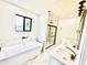 Bright bathroom featuring a soaking tub, double vanity, and walk-in shower at 1721 Thaddeus St, Indianapolis, IN 46203