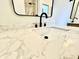 Close-up on a bathroom sink featuring marble countertop, modern faucet, and white basin at 1721 Thaddeus St, Indianapolis, IN 46203