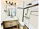 Updated bathroom featuring a glass-enclosed shower, modern vanity, and stylish black fixtures at 1721 Thaddeus St, Indianapolis, IN 46203
