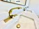 A modern bathroom with a double sink, beautiful gold fixtures and marble countertops at 1721 Thaddeus St, Indianapolis, IN 46203