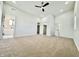 Bright bedroom featuring neutral carpet, ceiling fan, and entry to the bathroom at 1721 Thaddeus St, Indianapolis, IN 46203