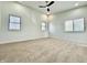 Bright bedroom with large windows, new carpet, ceiling fan, and neutral color palette at 1721 Thaddeus St, Indianapolis, IN 46203