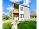 Modern two-story home with a wood balcony, gray siding, and a well-manicured lawn at 1721 Thaddeus St, Indianapolis, IN 46203
