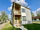 Two-story home with wooden decks and a well-maintained lawn under a sunny, partly cloudy sky at 1721 Thaddeus St, Indianapolis, IN 46203