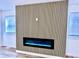 Modern fireplace with wood paneling and adjacent windows at 1721 Thaddeus St, Indianapolis, IN 46203