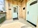 Inviting front porch with wood paneling, stylish lighting, and a welcoming front door at 1721 Thaddeus St, Indianapolis, IN 46203