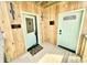 Inviting porch showcasing two doors, wood paneling, and a welcoming mat at 1721 Thaddeus St, Indianapolis, IN 46203