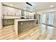 Bright kitchen with a large center island, stainless steel appliances, and light wood flooring at 1721 Thaddeus St, Indianapolis, IN 46203